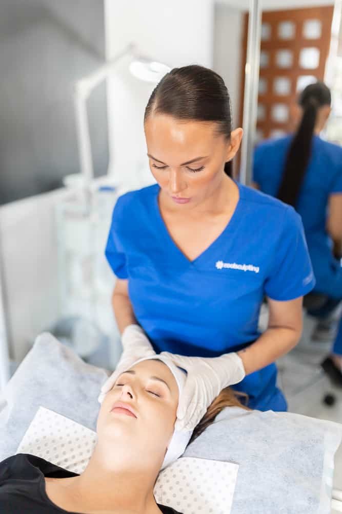 Ally applying IPL Treatment to a patient