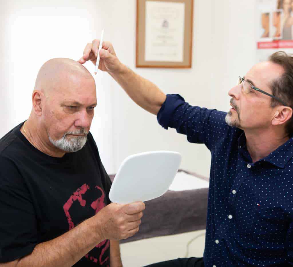 Hair Loss Treatments Dr Chris Leat performing a hair transplant consultation